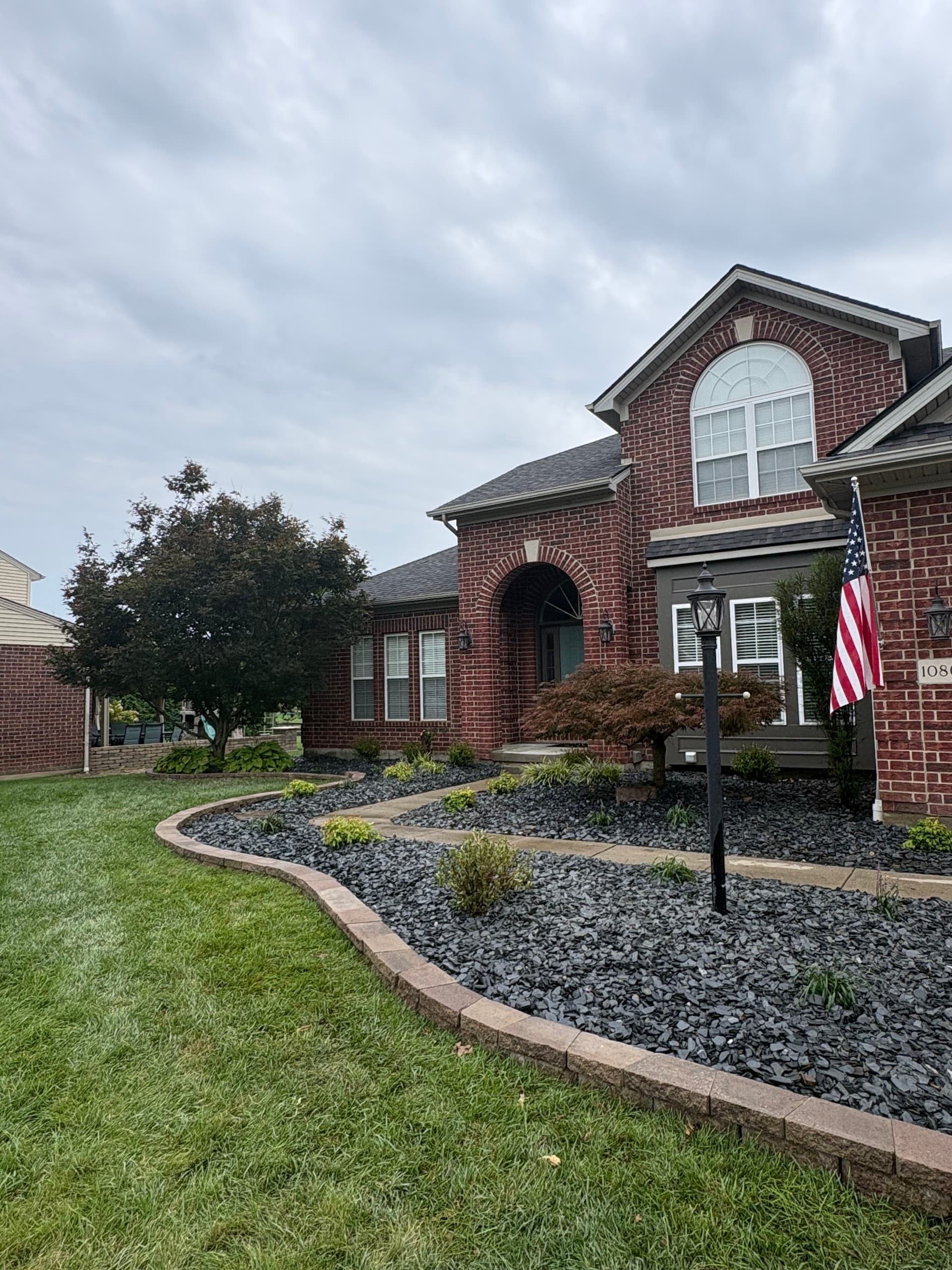 Black Slate Rock and Brick Edging Give This Home Serious Curb Appeal image